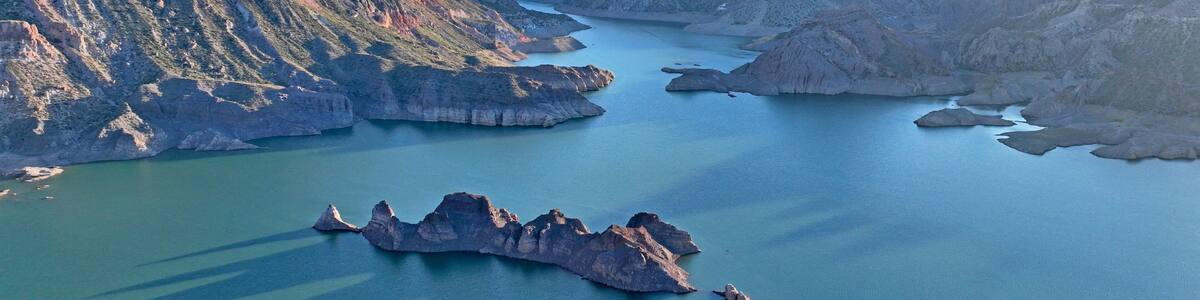 A canyon with a river and a rocky island.