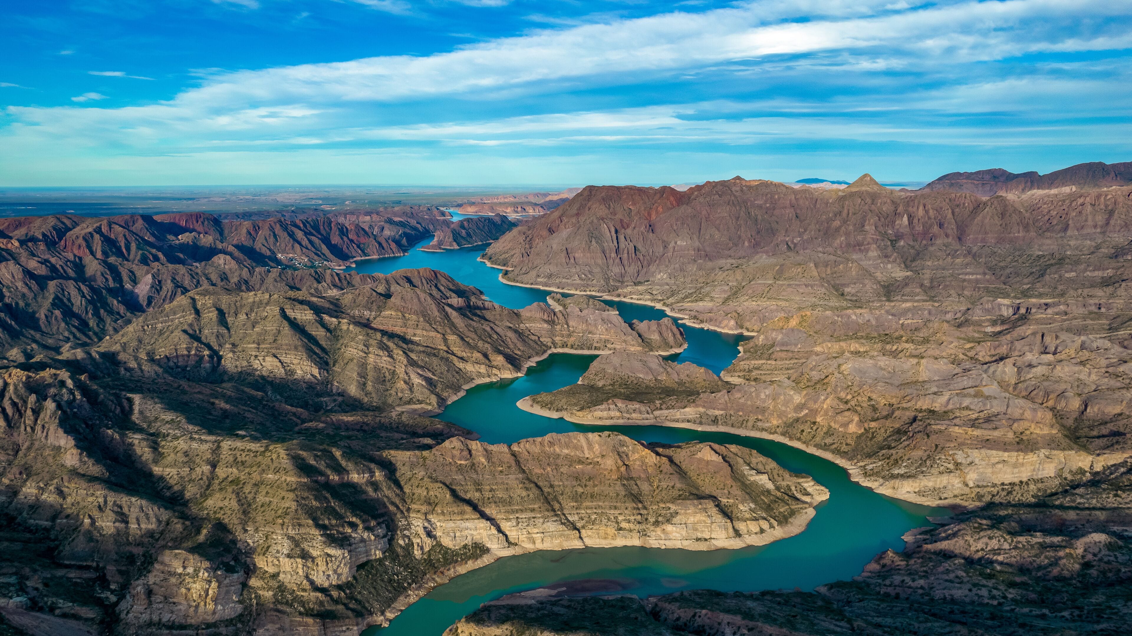 A river winding through a rugged canyon landscape.