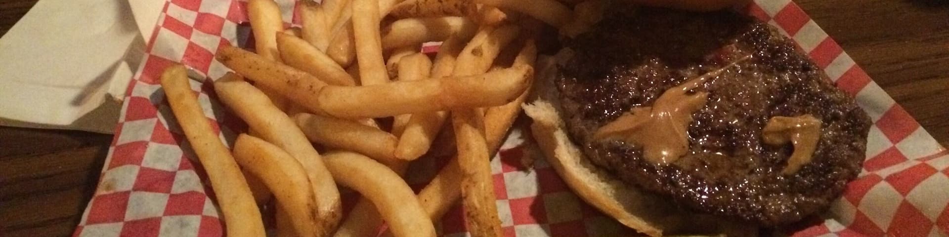 Excellent burgers with unique toppings, this particular one was slathered in peanut butter. Order a Schell's beer or a cold draft of Grainbelt on the side! #Delicious