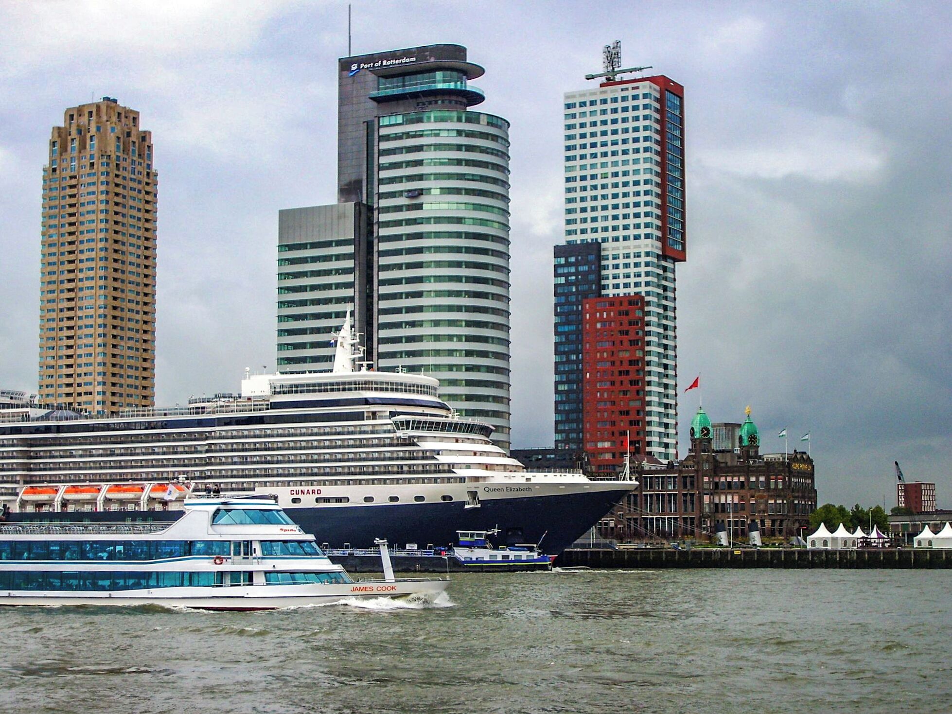 Busy Rotterdam waterways showing Cunard's Queen Elizabeth on her maiden visit.