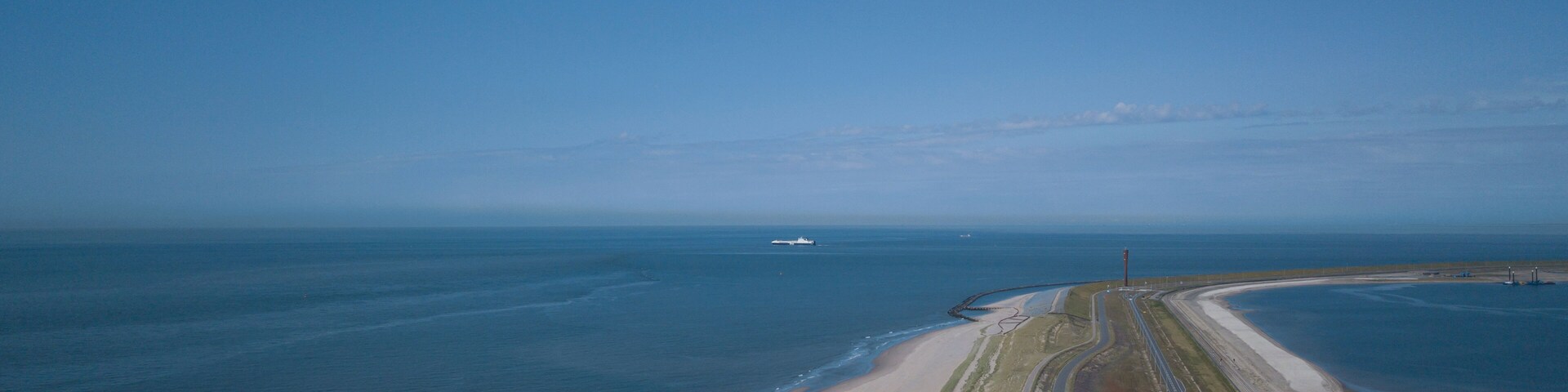 A coastal highway with a beach and ocean.