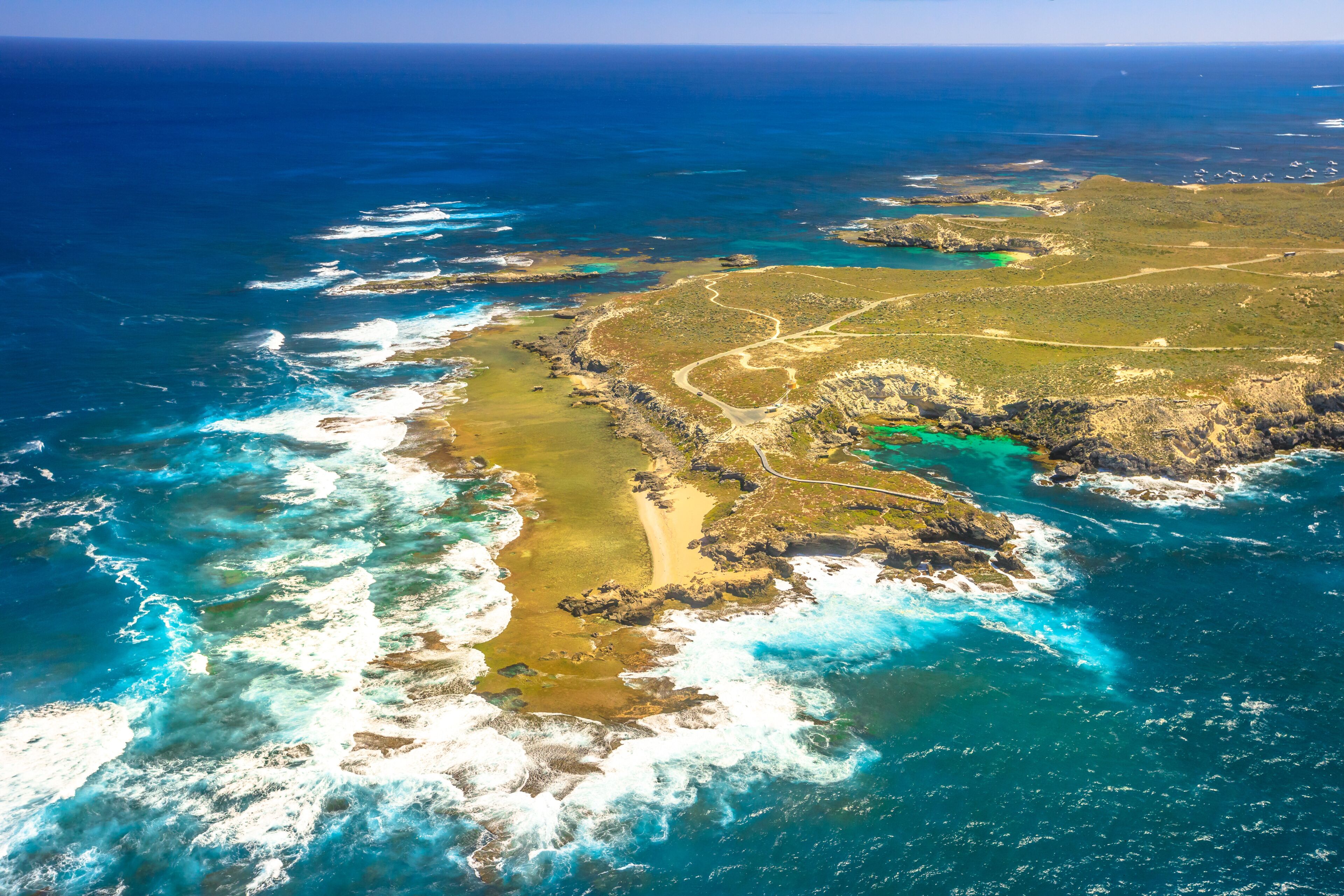 Aerial view of West End, the most popular western point of Rottnest Island, Australia, a rugged piece of coastline famous for waves, wind and seals. Scenic flight over famous tourist destination of WA
