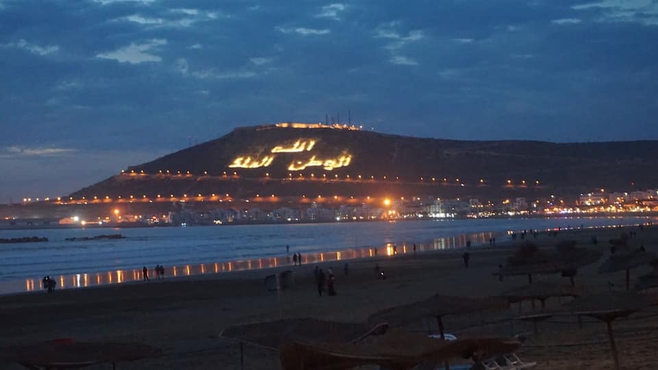 Agadir, a city along Morocco’s southern Atlantic coast, in the foothills of the Anti-Atlas Mountains, is the capital of Agadir-Ida Ou Tanane province. A resort destination, it's known for its golf courses, wide crescent beach and seaside promenade lined with cafes, restaurants and bars. Agadir's hilltop kasbah was destroyed in a 1960 earthquake, but its original old wall remains standing.
The arabic writings on the kasbah is a reminder to people which means God, Nation and King.