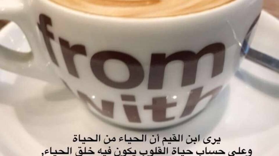 Una taza de café con diseño de latte en un platito.