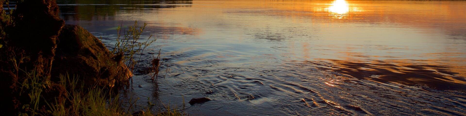 Rovaniemi which includes a sunset, landscape views and a river or creek