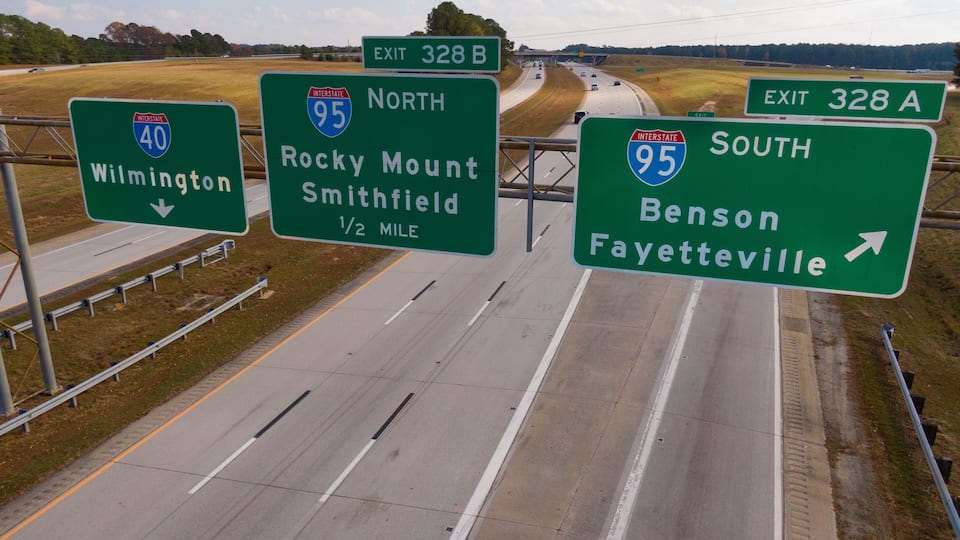 Highway signs indicating exits for Wilmington, Rocky Mount, Smithfield, Benson, and Fayetteville.