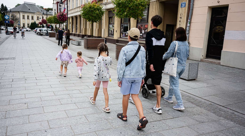 Family walking through a city street in Rzeszow, Poland on a cloudy day
