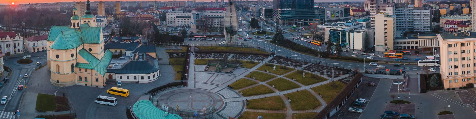 A cityscape with a prominent church, a roundabout, and modern buildings.