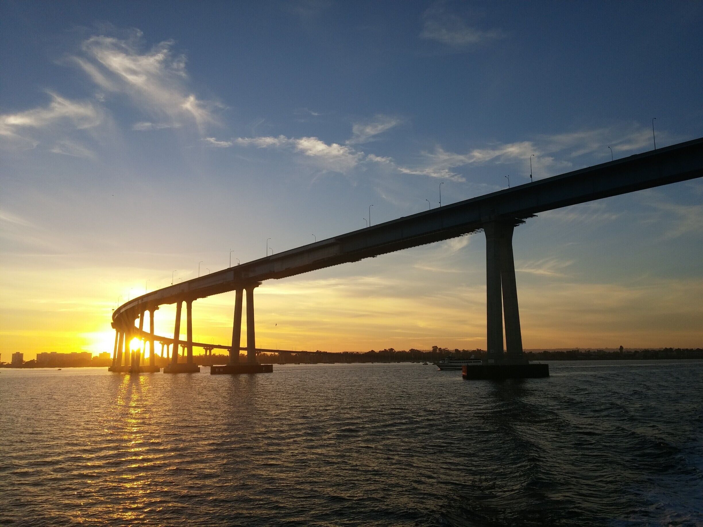 A bridge over water at sunset.