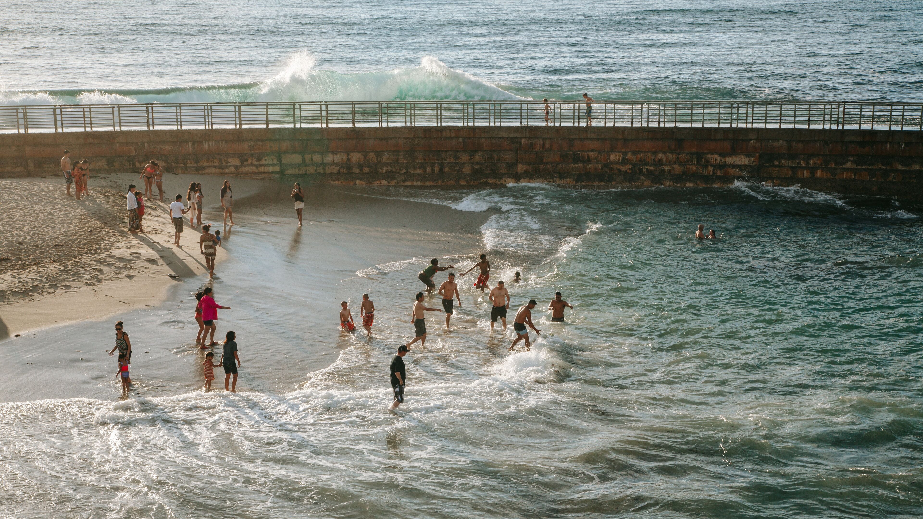 San Diego which includes swimming and a sunset as well as a small group of people