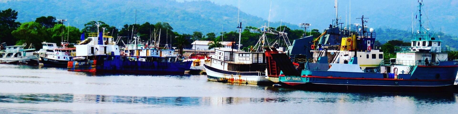 Looking back at the coastline of La Ceiba and all the many old boats and ships moored at the docks, from the deck of the ferry, Utila Dream, as the ferry is leaving La Ceiba for The Caribbean island of Utila. #blue