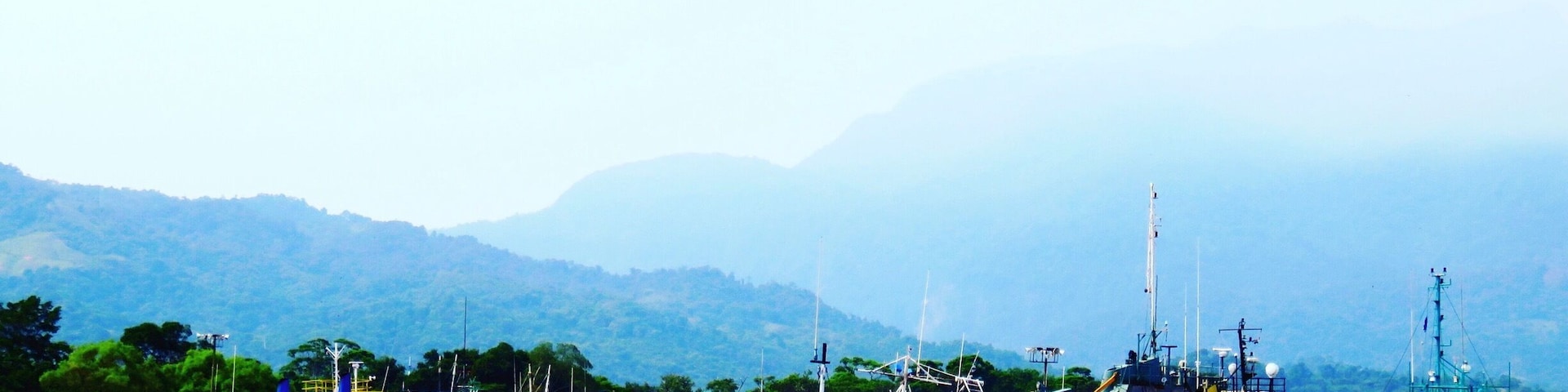 Looking back at the coastline of La Ceiba and all the many old boats and ships moored at the docks, from the deck of the ferry, Utila Dream, as the ferry is leaving La Ceiba for The Caribbean island of Utila. #blue