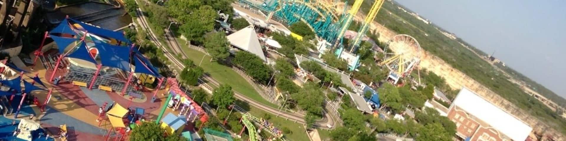 An amusement park with roller coasters, a Ferris wheel, and various rides.