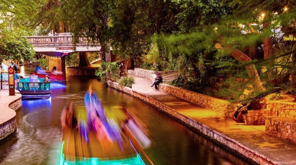 Long exposure photography on the San Antonio Riverwalk. Sight seeing boat on the river.