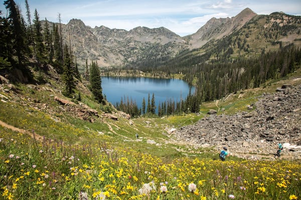 A mountain lake surrounded by forest and rocky terrain.