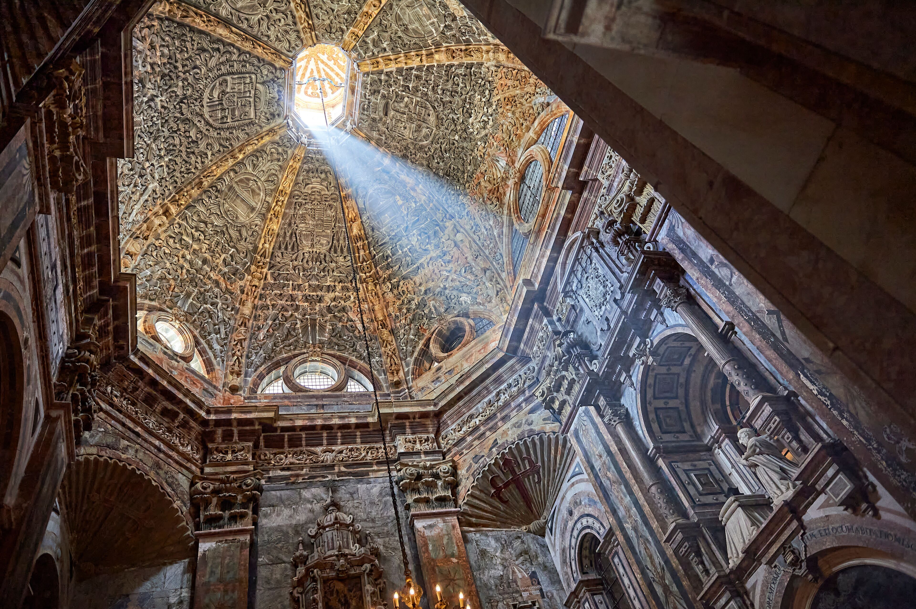 a ray of sunlight enters through the  dome of the chapel of El Pilar in the cathedral of Santiago de Compostela