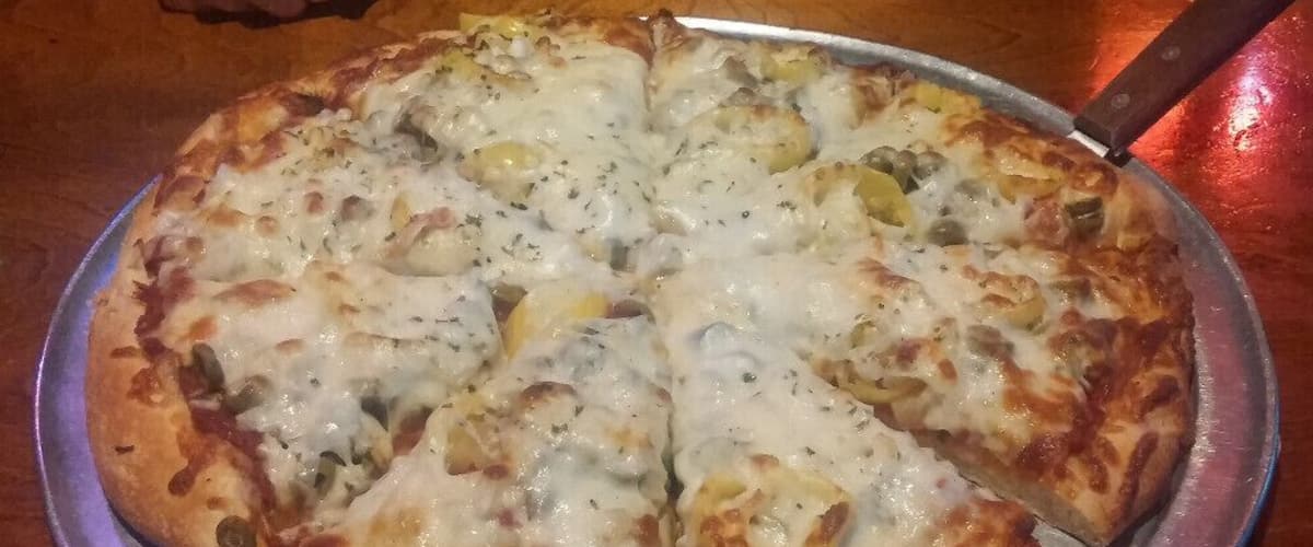A pineapple, onion, banana pepper and green olive pizza from Wick's original location in The Highlands.