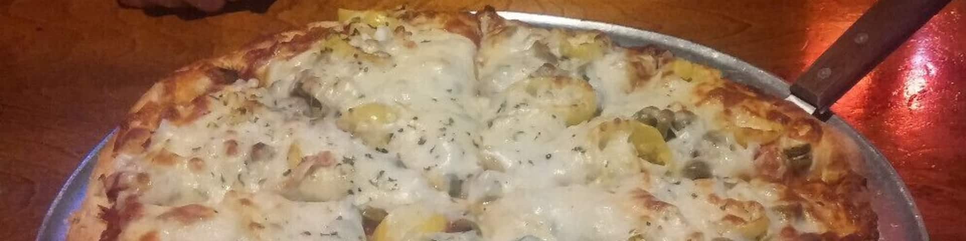 A pineapple, onion, banana pepper and green olive pizza from Wick's original location in The Highlands.