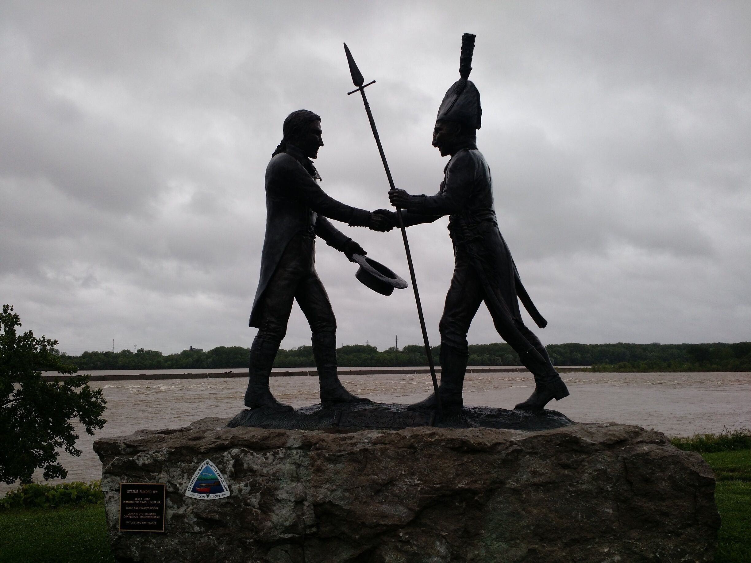 Shilouette of the statue at the entrance to the park on a gloomy day. 