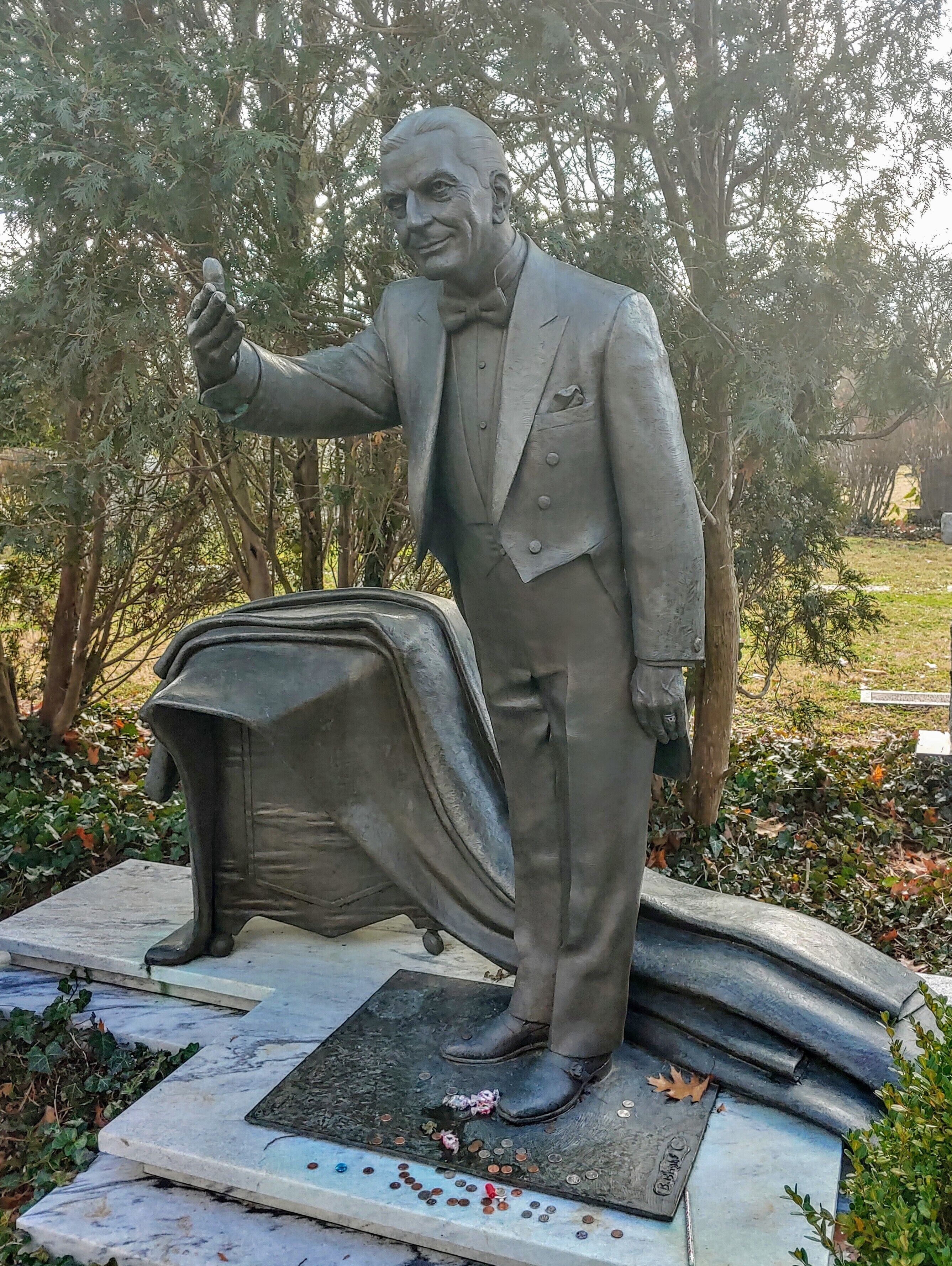 This man, Harry Leon Collins, held a job I didn't even know existed. He was the corporate magician for Frito Lay.

This statue was sculpted by fellow Kentuckian and eternal neighbor at Cave Hill Cemetery, Barney Bright.