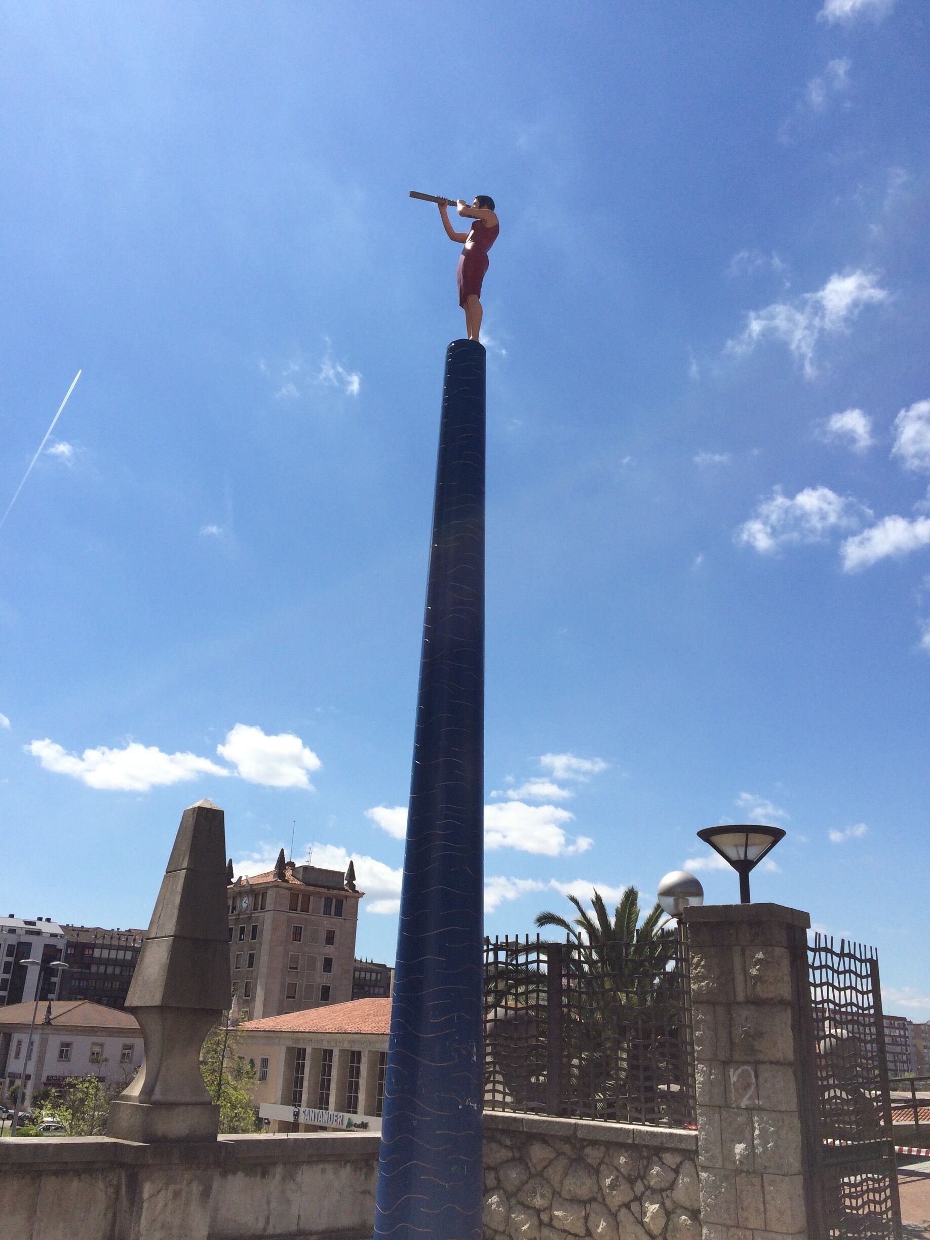 This very high statue of a woman looking through a telescope in central Santander is called Into the future 