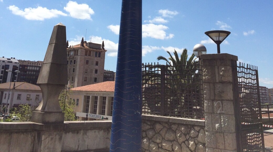 This very high statue of a woman looking through a telescope in central Santander is called Into the future
