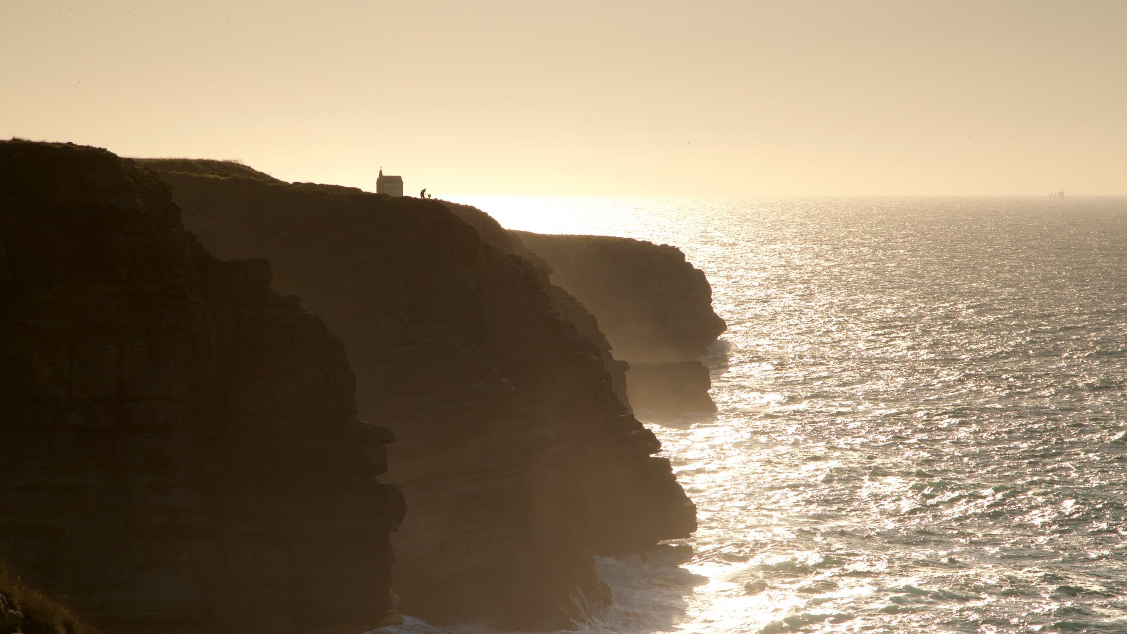 Santander featuring rocky coastline, general coastal views and a sunset