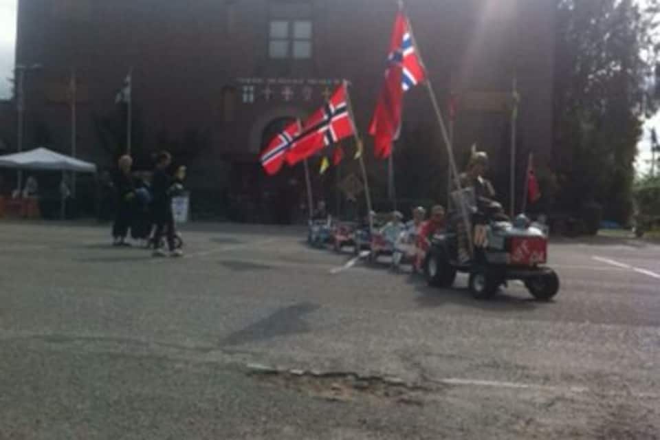 A parking lot with several flags and a vehicle.