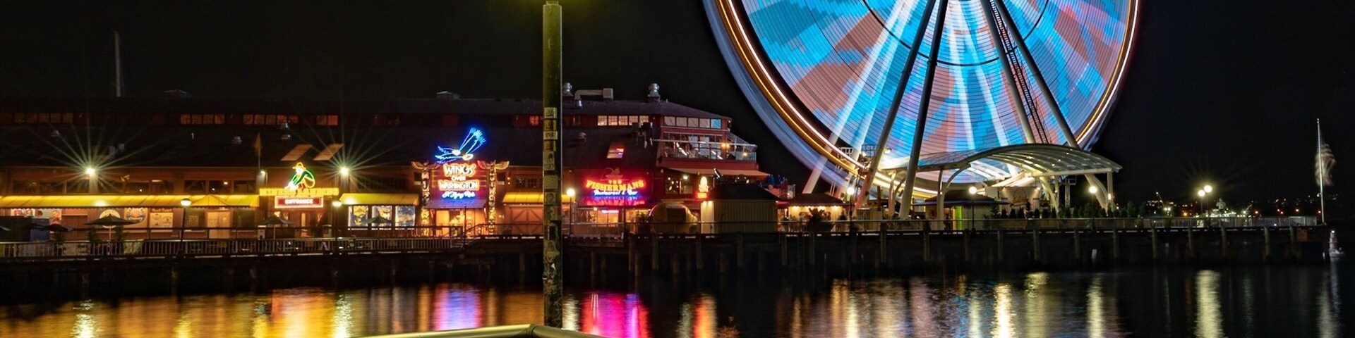I must credit @AnneArchambault for this post. She was the one originally that had the eye for this shot. When I saw it, I couldn’t help but try to recreate it for myself, with my own interpretation. I believe I took this shot a little further out than Anne did (as I took it from the second corner of the pier, instead of the first. I just love the colors that reflect off of the water here.
It does appear that there have been some changes to the pier since Anne shot her photo. I noticed that the “Wings Over Washington must be fairly new as it wasn’t in her shot as well as the chairs seem to have changed. I actually prefer the chairs in her shot to mine, but these metal ones had to do for mine. I also notice that the colors of the Ferris Wheel on the night Anne shot her photo had greens and yellows where mine was just blue and pink. I do like the colors of the Ferris Wheel on Anne's photo better
Overall, great place to visit. My wife and I got in line for the Ferris Wheel and the views are fantastic. If you happen to be in Seattle, you should definitely check this out!
#Seattle #GreatWheel #FerrisWheel #Pier #Pier57 #colorful #Night #reflection #water