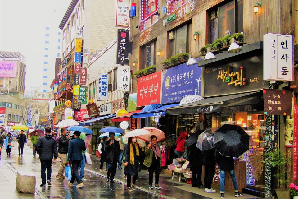 A busy street with shops and signs in a foreign language.