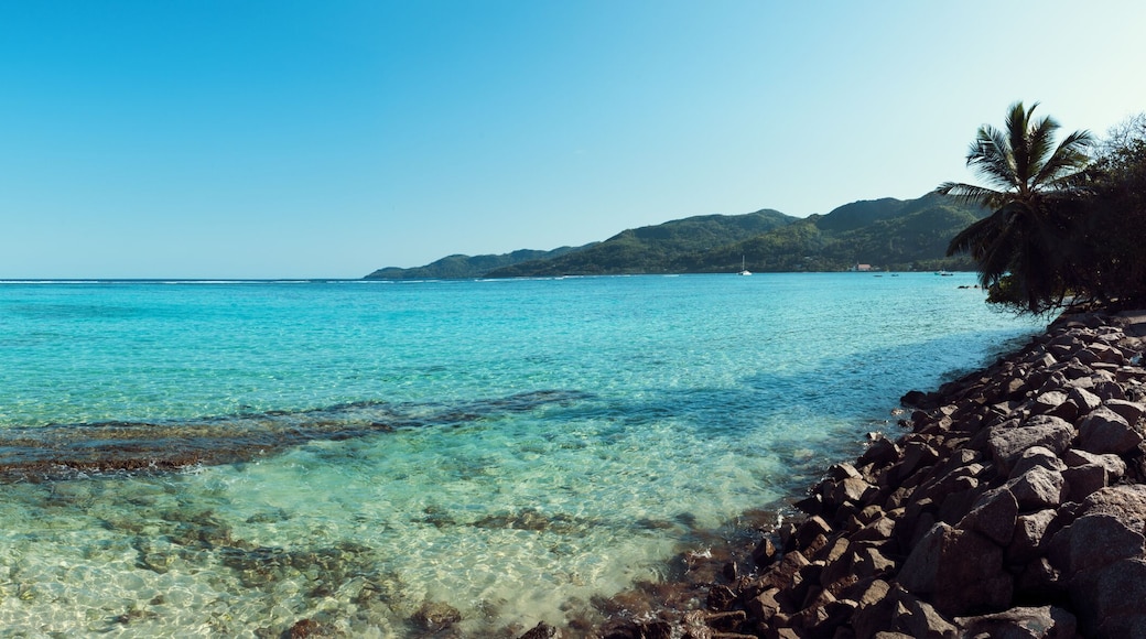 A stunning wide panoramic large format photograph of The stunning Anse royal beach in the seychelles, island of mahe. Paradise and beautiful blue sky.