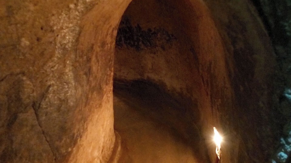 A cave entrance with a narrow passage.