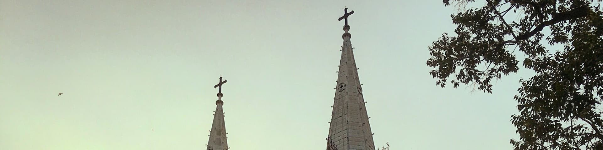 A large church with two tall spires and a prominent clock tower.