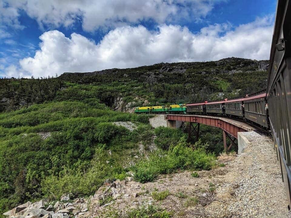 Go to Skagway by an Alaskan Cruise and you will get to take a train ride from Skagway to White Pass.  Slow and steady, this forty mile round trip excursion climbs from tidewater at Skagway to the Summit of the White Pass - a 2,888 foot elevation. The fully narrated tour passes through two tunnels, over sky-high trestles and cascading waterfalls.  Sit inside the cabin to listen to the narration on the way to White Pass.  You can take photos on the way back.  #LifeAtExpedia 