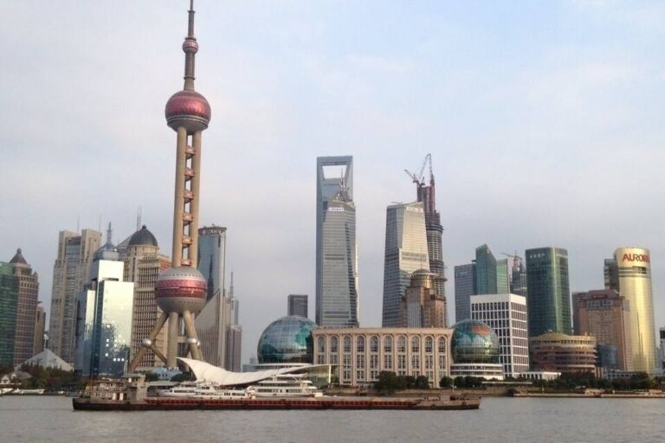 A city skyline with a prominent tower and modern buildings.
