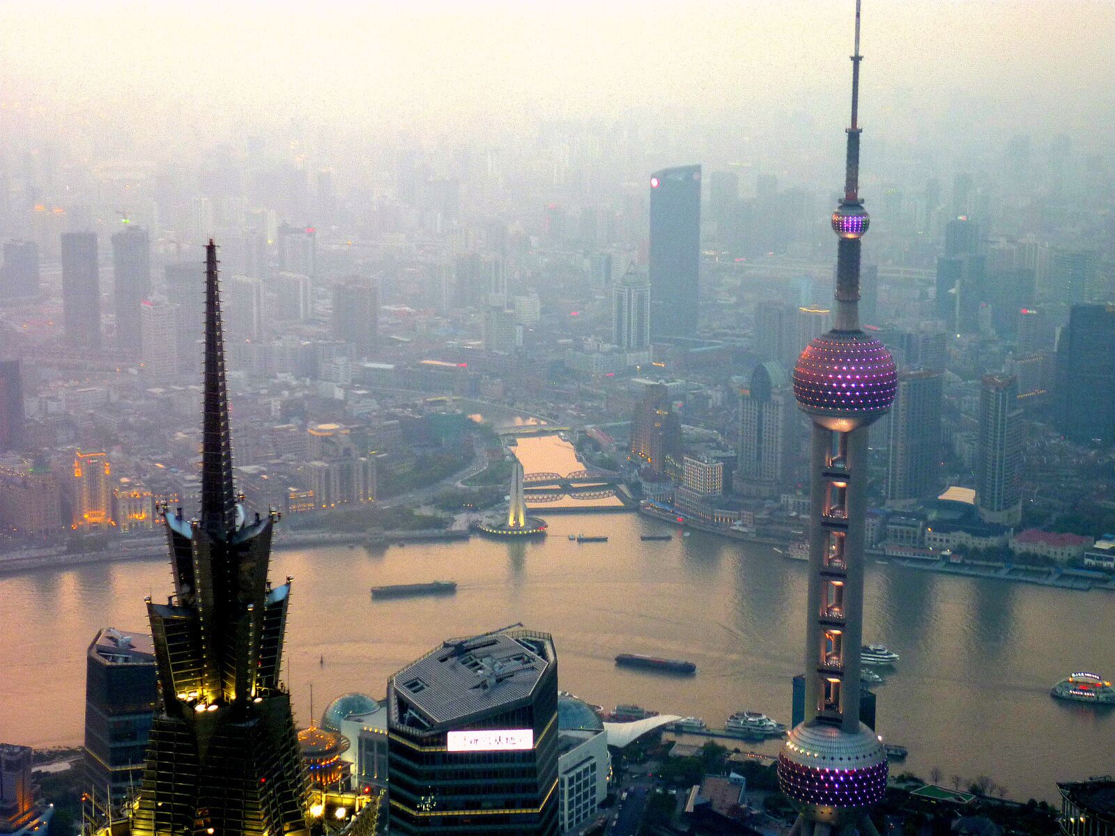 #LifeAtExpediaGroup Shanghai spread out below as the sun sets. Always an amazing feeling looking down on such massive buildings, while also being looked down on by the massive Shanghai tower behind.