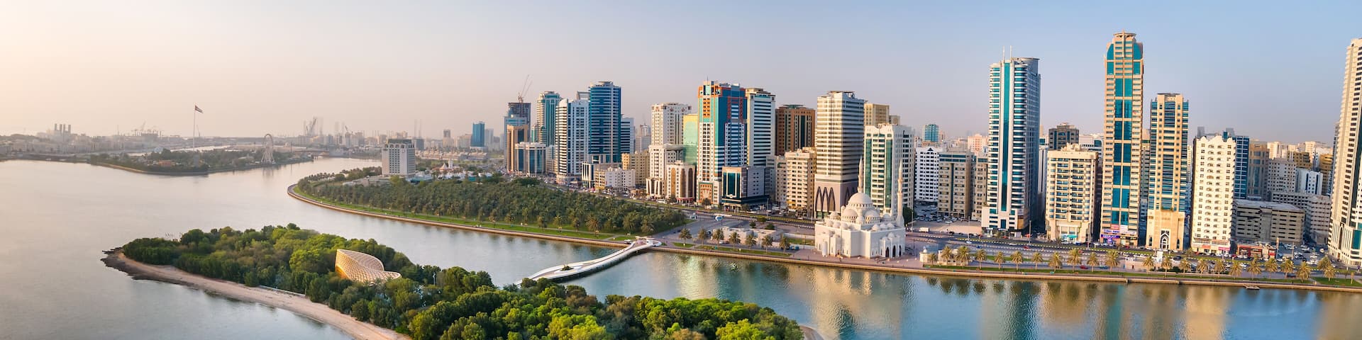 Sharjah aerial panorama above Al Noor island and mosque and downtown rising above Khalid lake