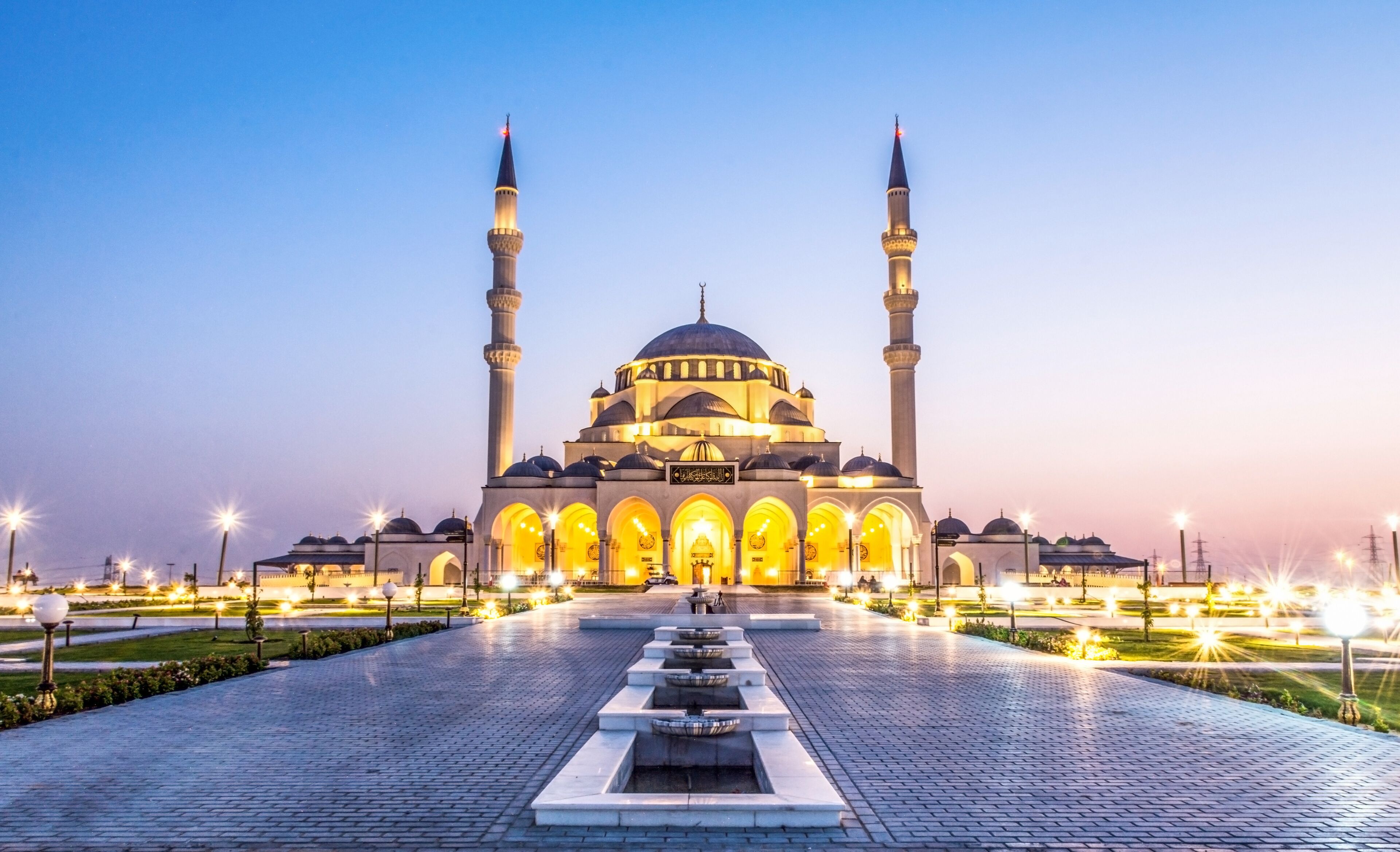 Largest Mosque in Sharjah beautiful traditional Islamic architecture new tourist attraction in Middle East evening shot of New Sharjah Mosque