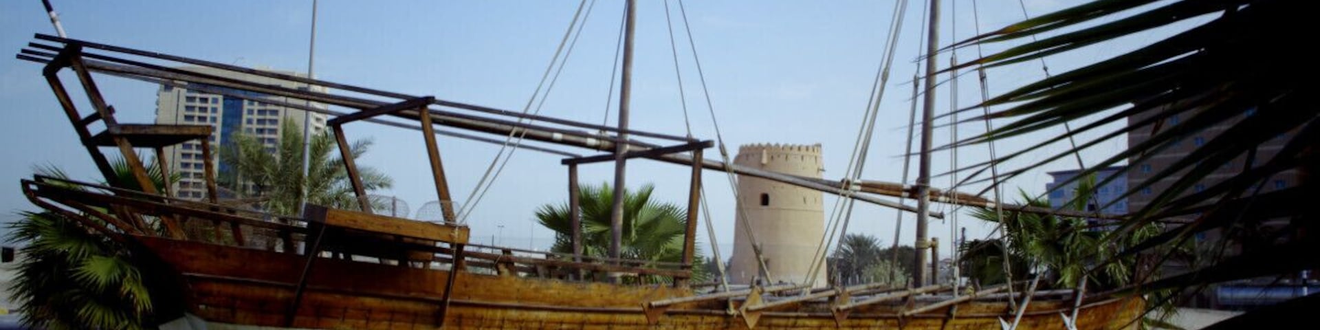 Ancient Sharjah UAE, old boat with an ancient fort in the background