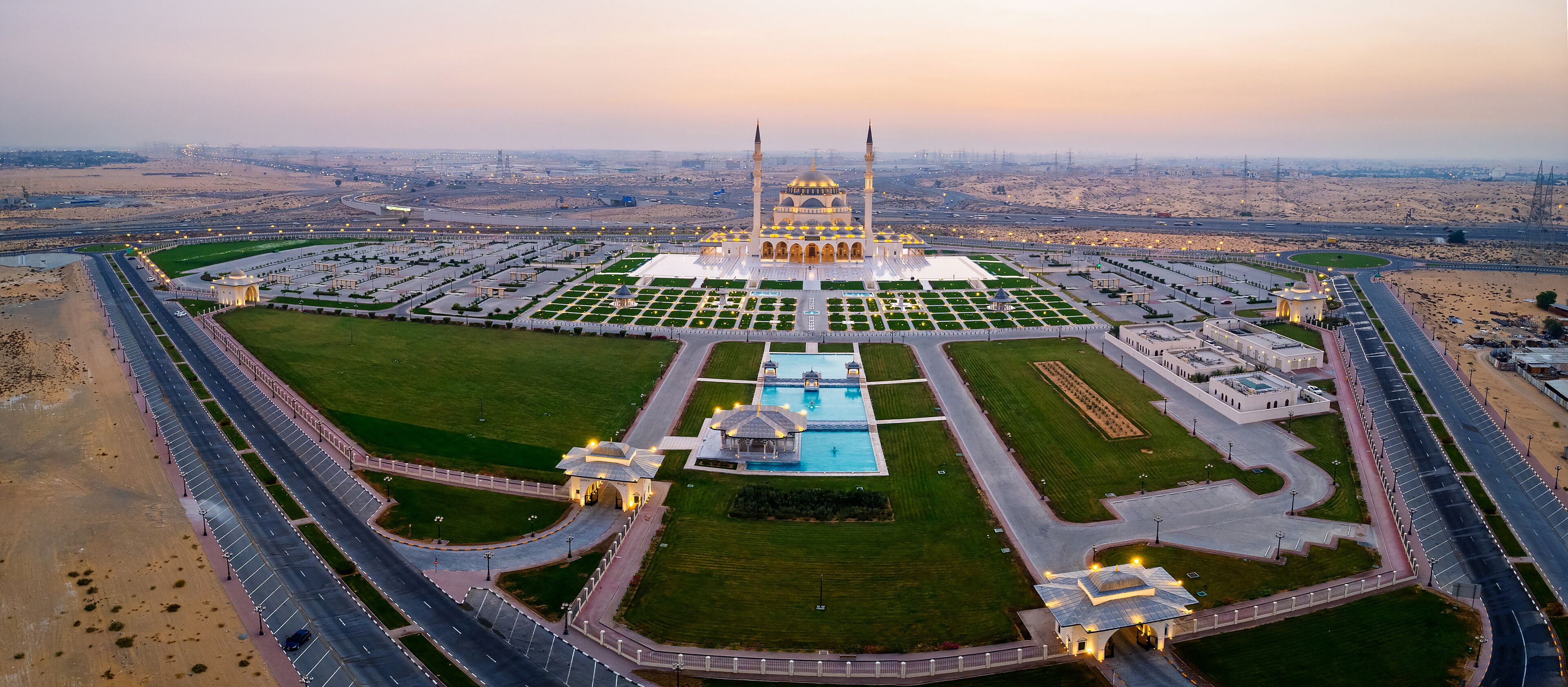 Aerial View of Sharjah Mosque at Sunset Showcasing Symmetrical Islamic Architecture