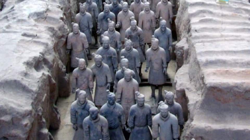 A large number of terracotta soldier statues arranged in rows.