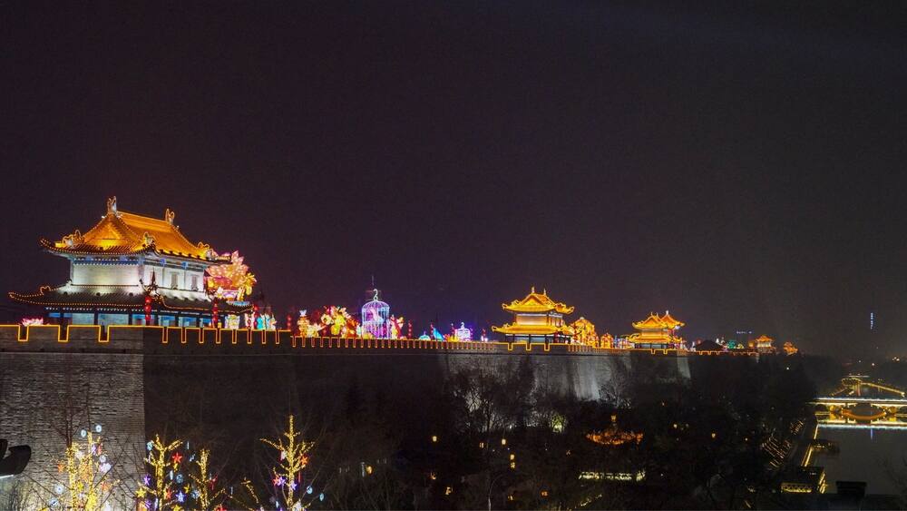 A traditional Chinese building with illuminated decorations at night.