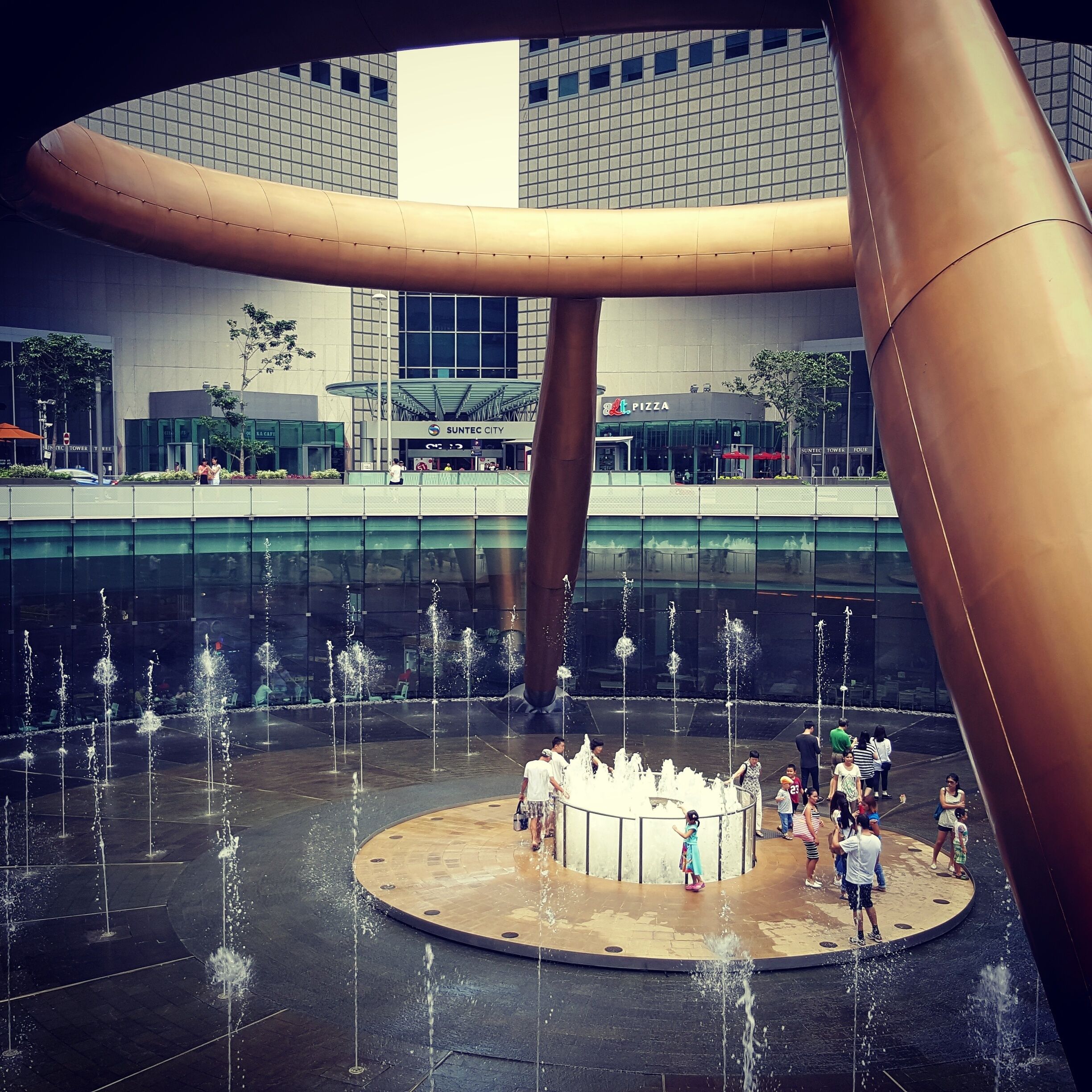 Every fortune seeker to this sunny island set in the sea must visit the Fountain of Wealth.

At enchanted intervals, visitors are allowed inside to circle and touch the inner waters for luck and prosperity. 

Look straight up while you're at it and you'll notice you and all the tourist dollars you brought to Singapore firmly reside in a giant palm surrounded by the five fingers of Suntec City. This is fengshui at its best.  #LoveMyTown