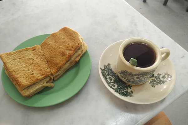 #TroveOn in Singapore. Kaya Toast with Butter and a Tea-O at the Ya Kun Kaya Toast location in Far East Square. This is a typical Singapore an breakfast which I'm having as an appetizer for lunch. Lol. They put a thick slab of butter in the middle on two breads. It's quite a heavy fatty breakfast but you'll just sweat it off from the Singapore an heat.
