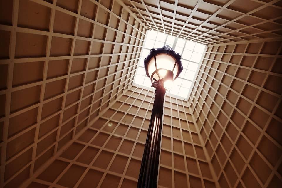 A view of a dome ceiling with a central light fixture.
