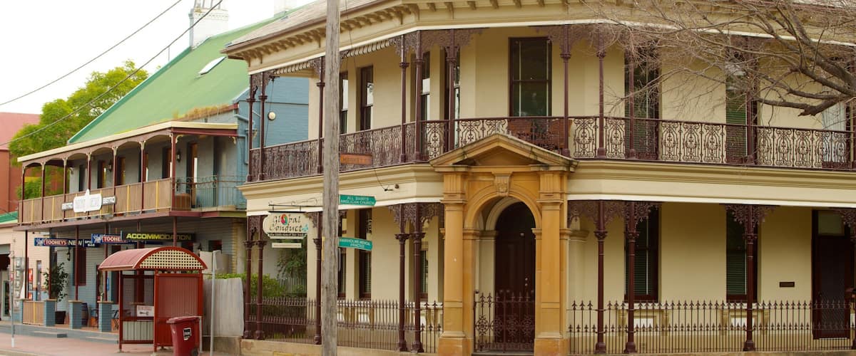 A historic building with ornate balconies and a green roof.