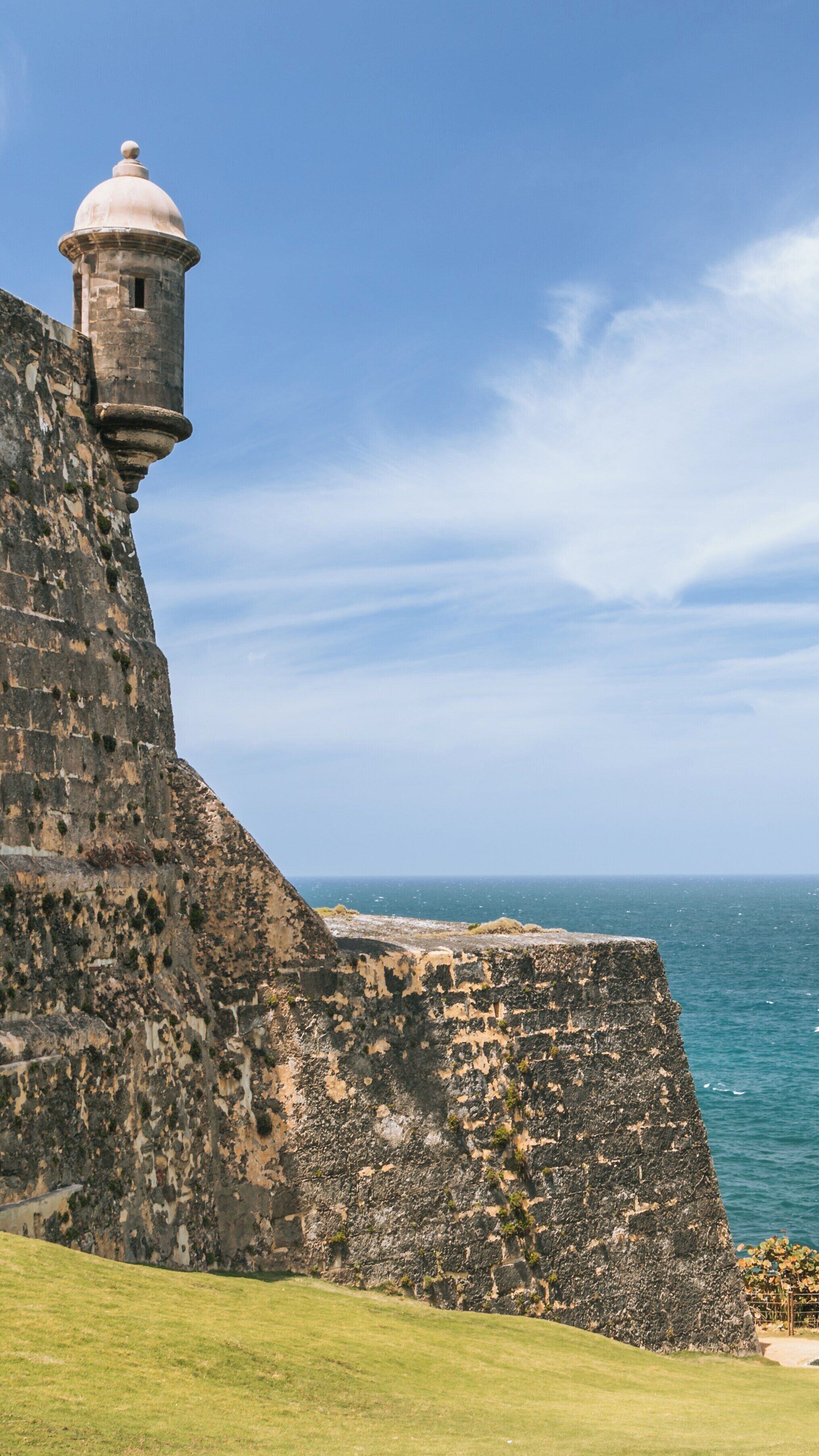 Exploring Castillo San Felipe del Morro in Old San Juan, Puerto Rico, with stunning coastal views and historic architecture under a clear blue sky