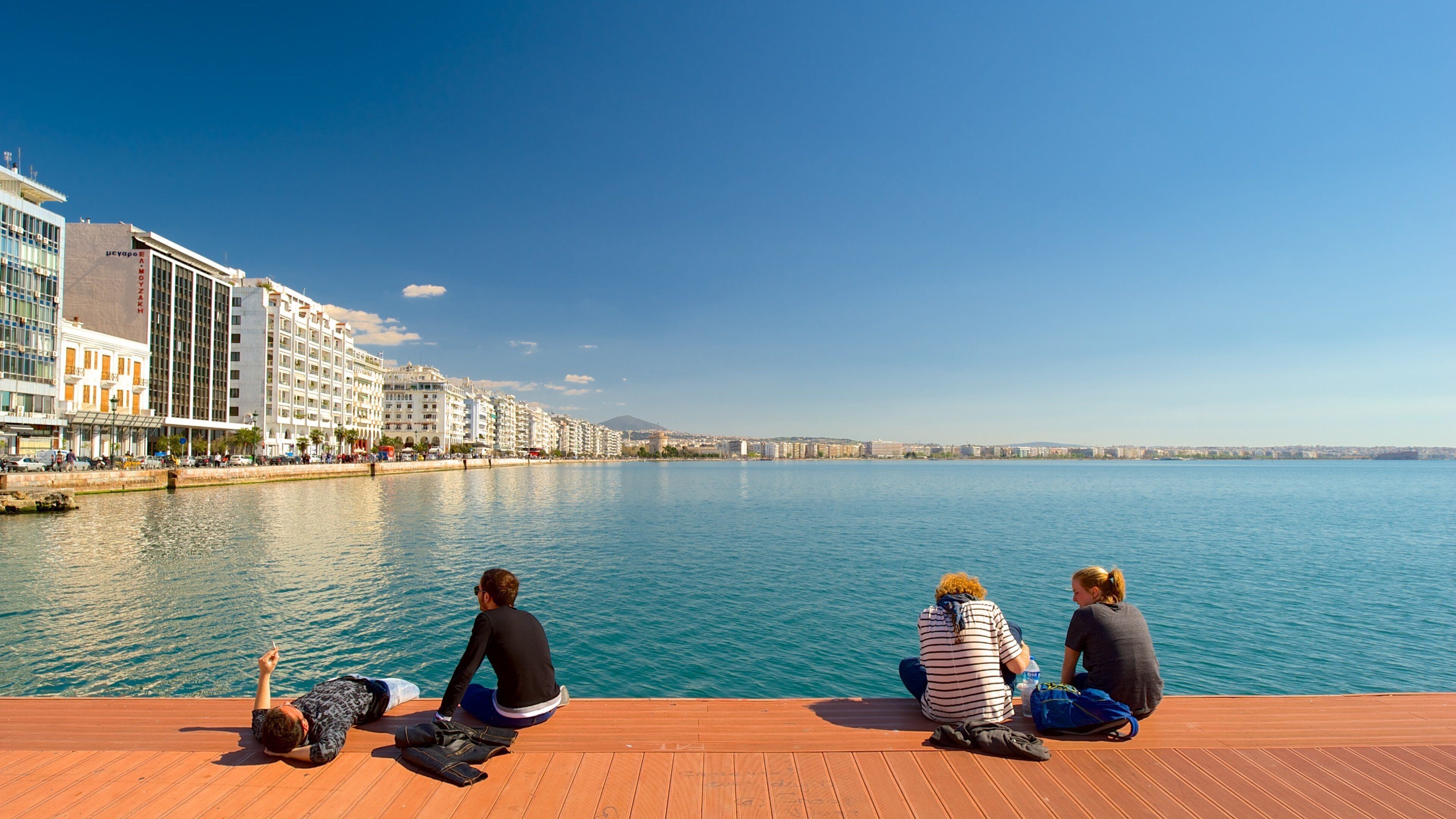 Thessaloniki showing general coastal views and a coastal town as well as a small group of people