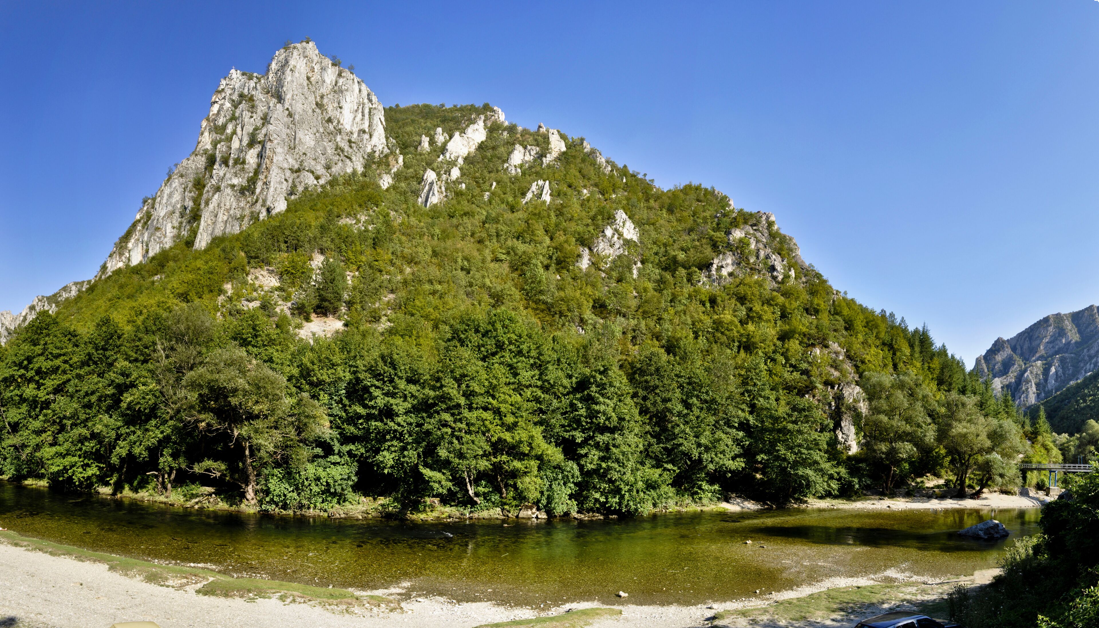 Panoramic view of Treska River flowing  through the overgrown rocky hills of Matka Canyon. A popular tourist attraction in Skopje, Macedonia.
