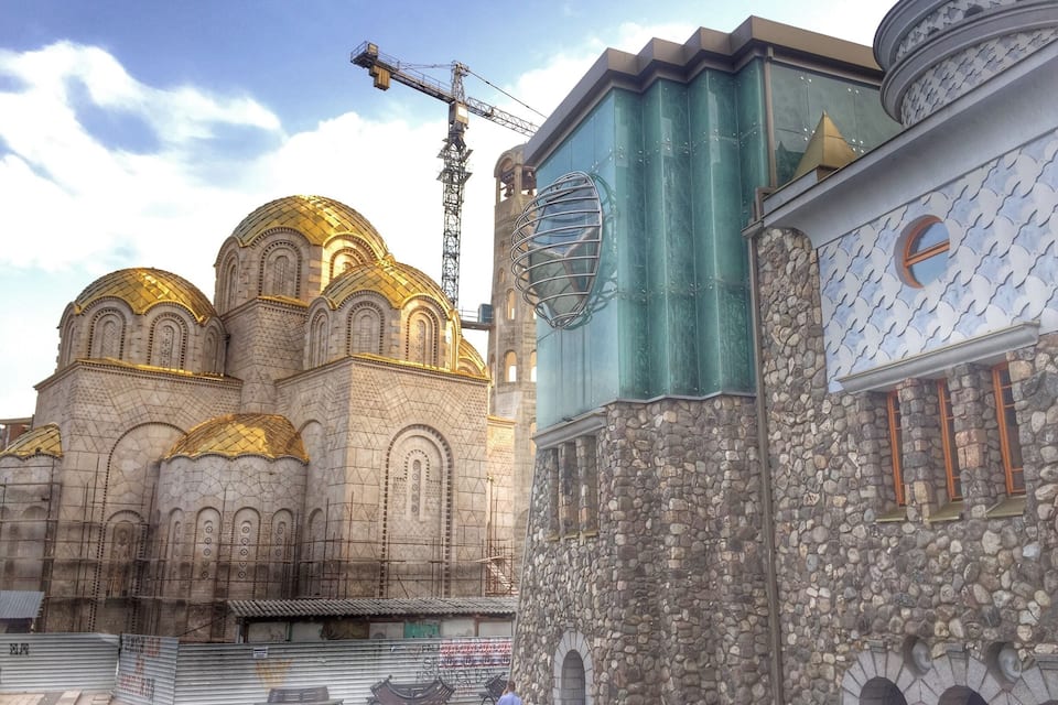 A historic church with golden domes and a stone building with a patterned roof.